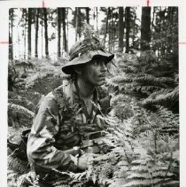 Fort Ord -field maneuvers: soldier in forest with weapon
