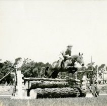 11th Calvary: horse jumping a log barrier
