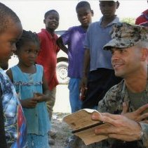 U.S. Marine Uses a DLI Language Survival Guide in Haiti, 2016.