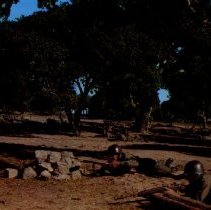 Color image of soldiers training on the field with a sargeant supervising