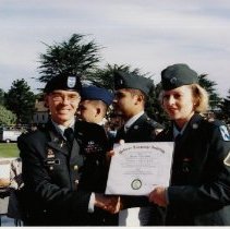 Colonel Michael R. Simone, Commandant Defense Language Institute Foreign Language Center (DLIFLC), awards Private First Class (Pfc.) Heather Noel White her Associate of Arts (AA) Degree in French.
