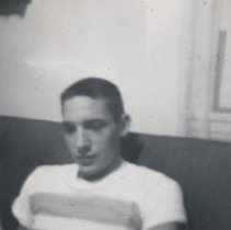 Civilian Man Sits on Couch at Home