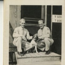 Sergeant First Classes Sit on Porch with a Dog
