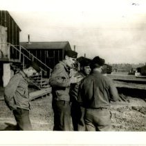 Soldiers Deep in Conversation on an Unpaved Street