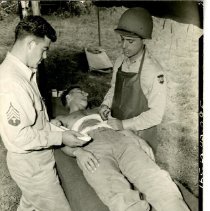 Army Medics Wraps a Soldier's Abdomen in Gauze
