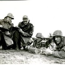 Staff Members Observe Trainees Setting up Machine Gun at Fort Ord