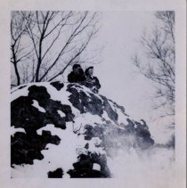 Couple Enjoys the Snow while Sitting on a Hill