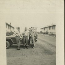 Trio of Soldiers Lean Against a Jeep at Fort Ord