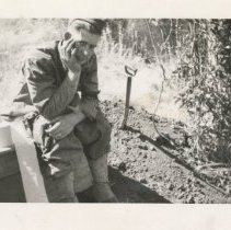 Soldier Sitting on Outdoor Toilet at Fort Hunter Liggett