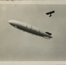 US Navy Rigid Airship and Biplane Fly over San Francisco