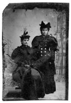 Tintype photo of two women in nice dresses and fancy hats