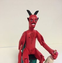 Seated Devil Drinking Mezcal