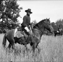 Actor in costume posing on horse