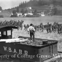 Buster Keaton on tender overlooking troops in field