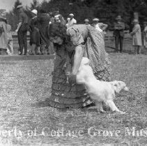 Marion Mack and dog with spectators in background