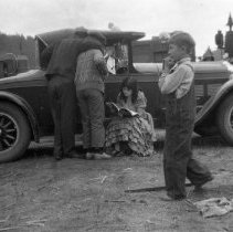 Marion Mack in costume reading between scenes