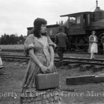 Marion Mack in costume with suitcase between scenes