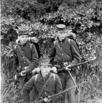 Three actors posing in soldier costumes