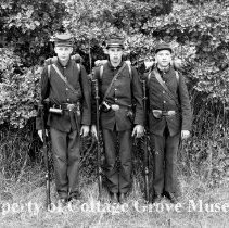 Three actors posing in soldier costumes