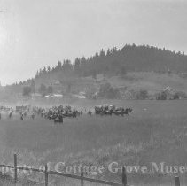 Troops moving through field.
