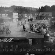 Soldiers on horseback leaving town with Engine #3 (The General) in the fore