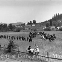 Troops and film crew on field set between scenes