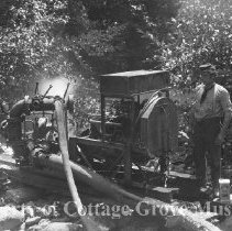 Man standing next to water pump