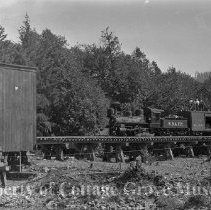 Film crew on top of train heading for covered bridge