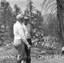 Film crew members discussing a scene on train wreck site