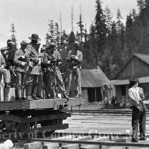 Buster Keaton on track with actors on flat car