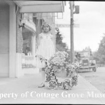 Girl with decorated doll carriage