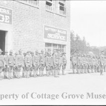 Soldiers in formation next to Woodson Brothers Garage