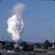 Blue Goose locomotive approaching crossing at 10th and Main Street