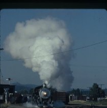 Blue Goose locomotive approaching crossing at 10th and Main Street.
