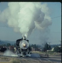 Blue Goose locomotive approaching crossing at 10th and Main Street.