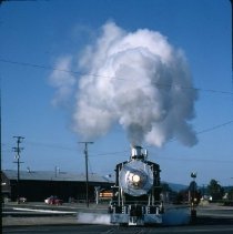 Blue Goose locomotive crossing at 10th and Main Street