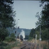 Blue Goose locomotive approaching crossing