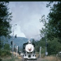 Blue Goose locomotive approaching crossing