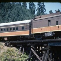 Boys in water near bridge at Rat Creek with Blue Goose approaching