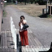 Woman taking photograph at Blue Goose depot