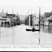 Man in row boat on flooded street