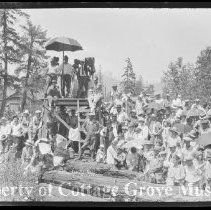 Film crew on camera platform with spectators below