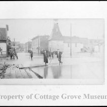 People standing at flooded intersection