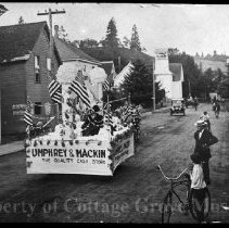 Parade float with small crowd on 6th St.