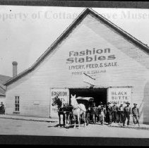 People, horses and carriage in front of Fashion Stables Livery