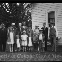Family posed in front of house