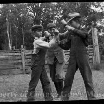 Three unidentifed boys play fighting
