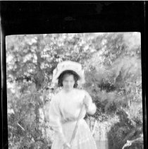 Unidentified woman posed on a makeshift raft