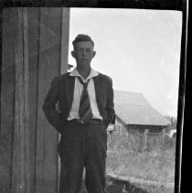Unidentified young man posed outside in front of building