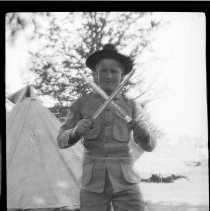 Unidentified boy in uniform with small swords